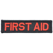A rectangular first aid patch with red text on a black background.