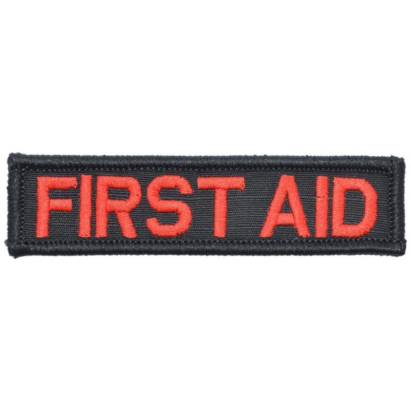 A rectangular first aid patch with red text on a black background.
